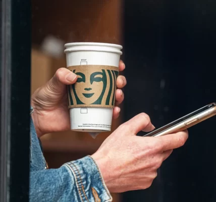 person holding starbucks cup