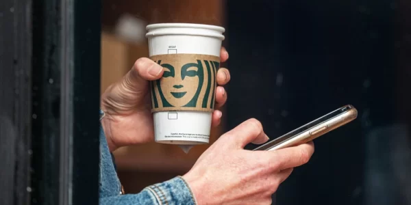 person holding starbucks cup