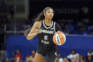 Angel Reese dribbles a basketball.