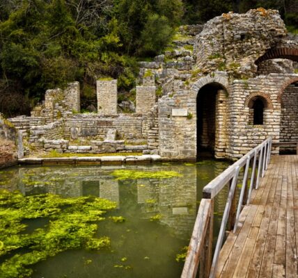 Old stone ruins connected by a bridge over water