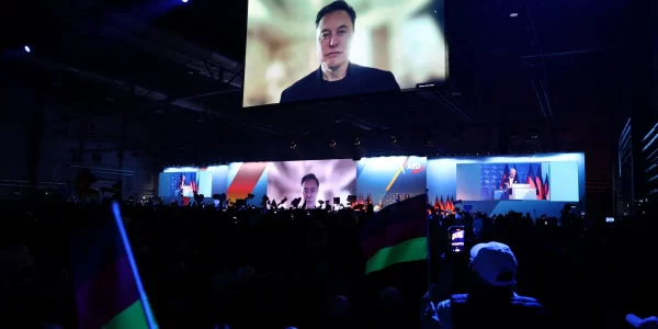 Elon Musk is seen on-screen at a campaign event for the far-right Alternative for Germany party, in Halle, Germany