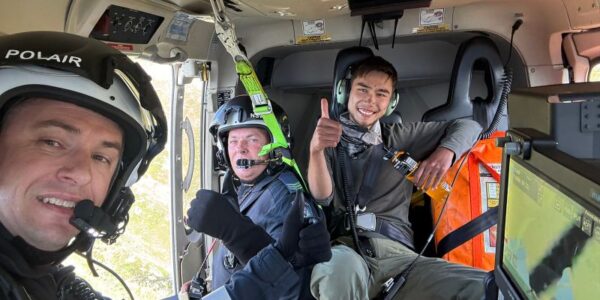 Rescued hiker on plane with first responders.