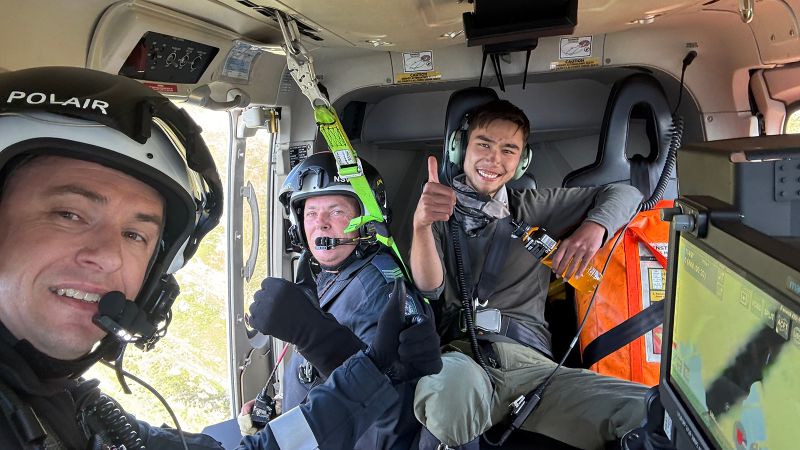 Rescued hiker on plane with first responders.