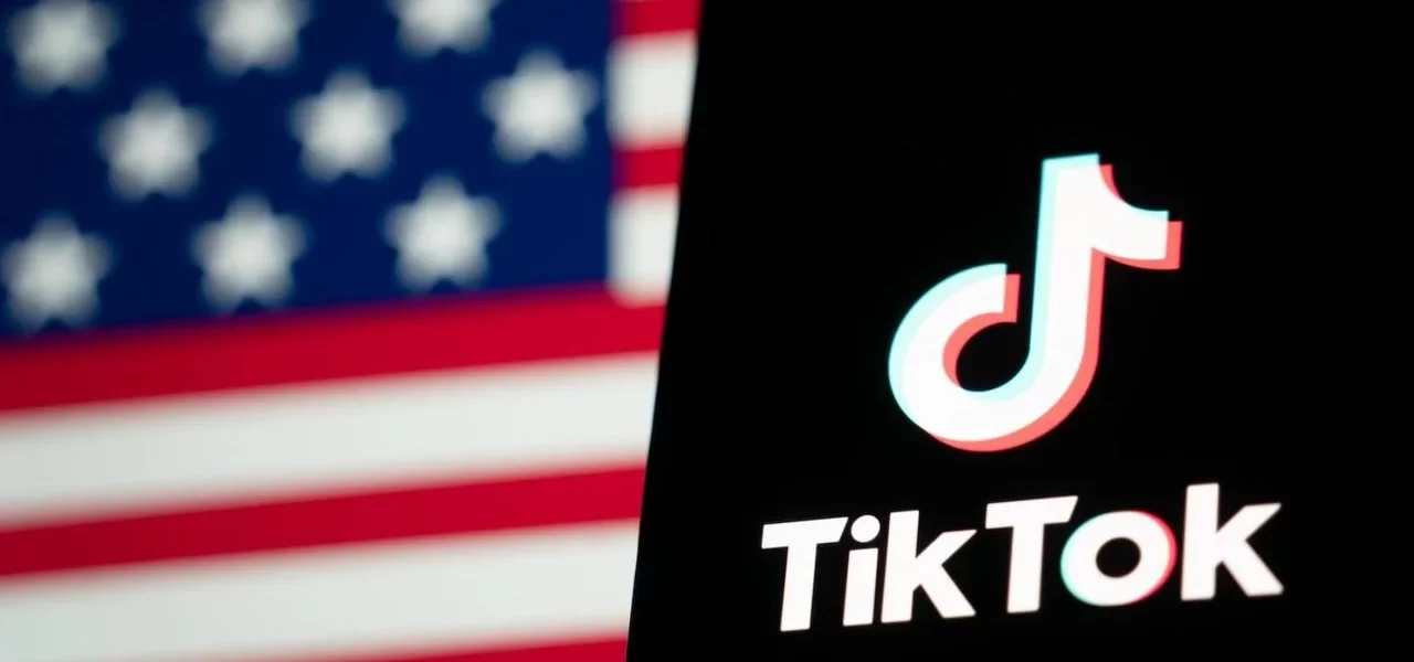 TikTok app on phone with blurred American flag in background.