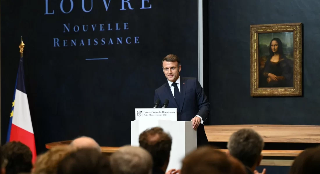 French president giving a speech in front of the Mona Lisa in the Louvre.