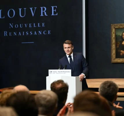 French president giving a speech in front of the Mona Lisa in the Louvre.