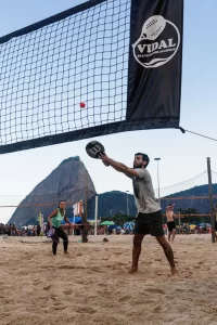 A man and a woman playing beach tennis