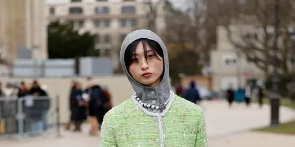 Yaqian Lan Donning winter 2025's most trending accessory- a knitted hood with a matching lime green tweed suit, Yaqian Lan brought a pop of colour to the Chanel show guestlist.