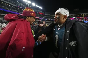 Jayden Daniels shaking hands with Jalen Hurtz