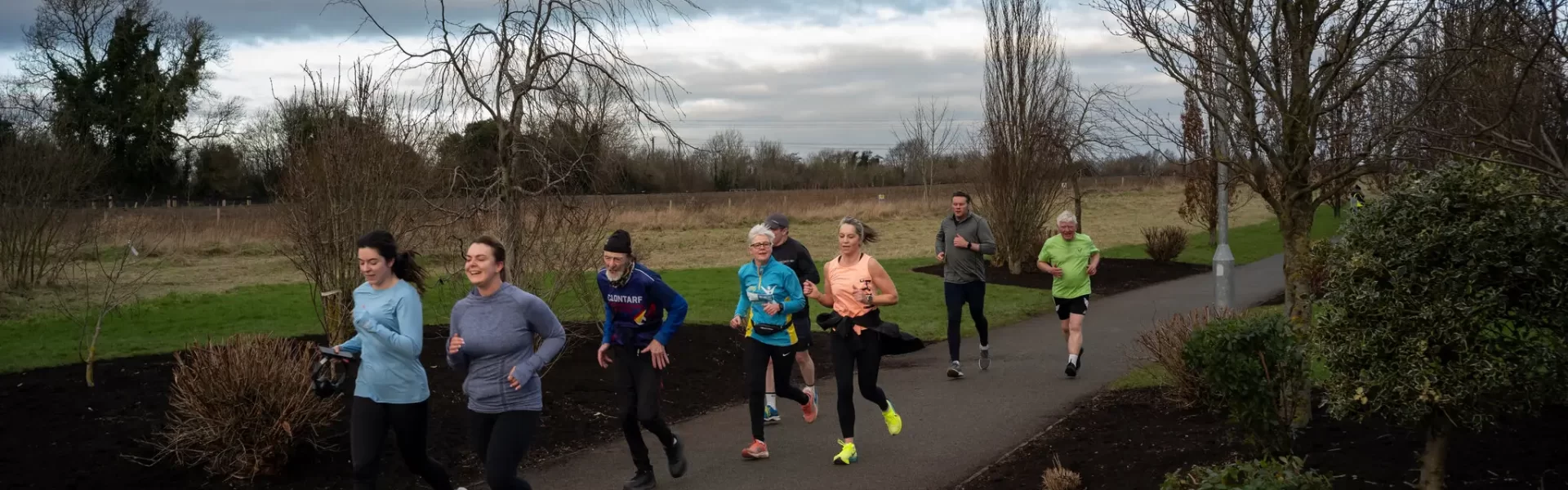 A group of people running through a park