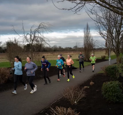 A group of people running through a park