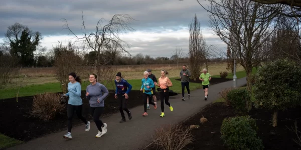 A group of people running through a park